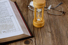 Hourglass And Open Bible Symbolizing The End Times According To The Holy Bible