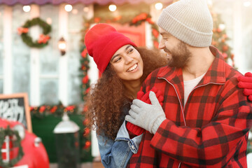 Sticker - Happy young couple celebrating Christmas outdoors