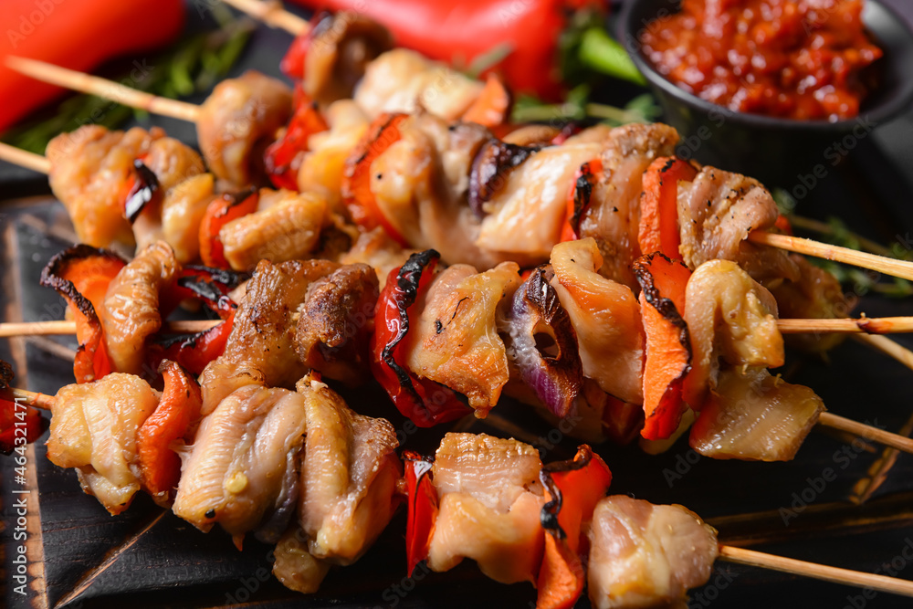 Grilled chicken skewers with vegetables on board