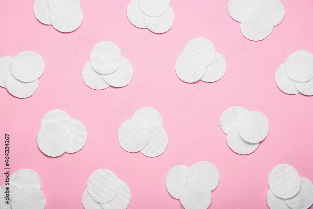Clean cotton pads on pink background