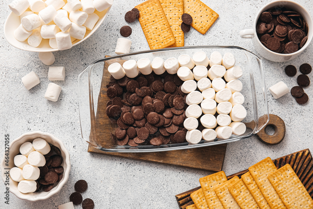Ingredients for preparing S'mores dip on light background