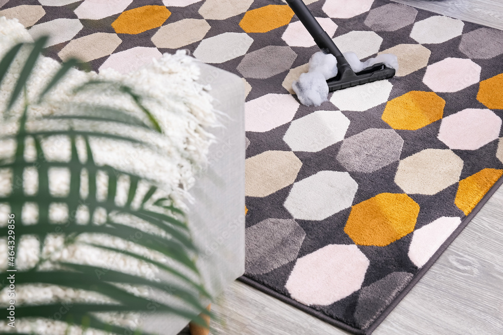 Vacuuming of carpet in room