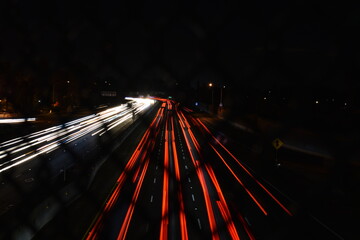 Wall Mural - A view of the street from a bridge surrounded by lights with long exposure at night