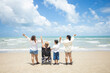 © nikomsolftwaer - Disabled woman asia in a wheelchair with his family on the beach. Wheelchair woman sitting relax on the beach.  family relax concept