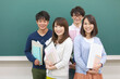© amanaimages - 黒板の前に立つ学生4人