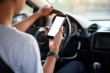 Wall Mural - cropped shot view the driver uses the phone while driving. modern smart phone with round edges. isol