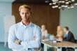 © Drobot Dean - Adult man standing with arms crossed in office during business meeting