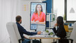 © DC Studio - Workmates using video call on television for conversation with woman about business project. Colleagues talking to manager on online conference for briefing strategy about presentation
