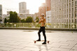 © Drobot Dean - Grey mature man with beard skateboarding on parking