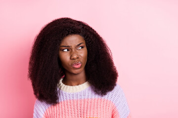 Sticker - Photo of unsatisfied dark skin girl sullen face look empty space wear sweater isolated on pink color background