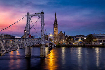 Wall Mural - Beautiful, illuminated cityscape of Inverness with Greig Street Bridge and River Ness during sunset, Scotland