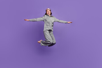 Poster - full body photo of mature woman happy positive smile jump up hands wings fly isolated over violet co