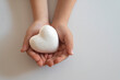 boy holding white heart in palm. Organ donation and insurance concept. World heart health concept. World organ donation day. Concept of healthy heart for healthy life. selective focus
