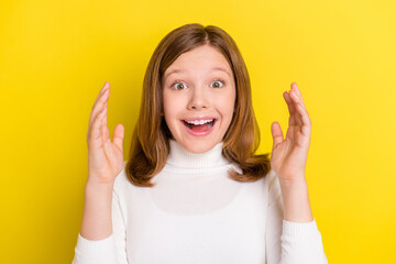 Poster - Photo of cheerful young positive small shocked girl hold hands sale news isolated on yellow color background