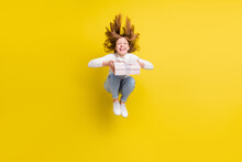 Full Body Photo Of Happy Brunette Young Little Girl Jump Hair Fly Hold Present Box Isolated On Yellow Color Background