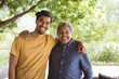 © Wavebreak Media - Portrait of smiling biracial adult son and senior father looking at camera and embracing