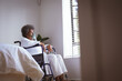 © Wavebreak Media - African american senior woman sitting on wheelchair with oxygen mask at home