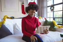 Happy African American Woman In Santa Hat Making Tablet Christmas Video Call