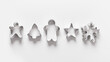 Christmas-themed cookie cutters for gingerbread on white background. Xmas creative concept themed family cooking and preparation for holiday. Banner. Top view, flat lay.
