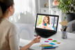 © Syda Productions - education, school and distant learning concept - female art teacher with laptop computer and picture of rainbow having online class with student girl at home