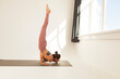 yoga and gymnastics, a young slender girl doing a scorpio pose, yoga practice on a white background