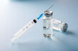© Olga Mishyna - Covid-19 coronavirus vaccine. Syringe and vaccine vial on blue background. Treatment for coronavirus covid-19. Safety at pandemic or quarantine. Stay safe. Preparation for injection