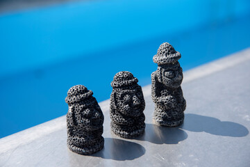 Three pairs of DolHarubang made of basalt, a symbol of Jeju Island in South Korea.