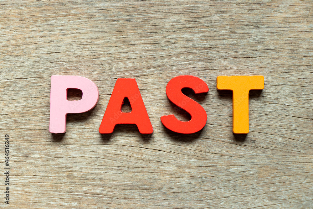 Color alphabet letter in word past on wood background