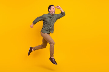 Sticker - Full length body size view of attractive amazed man jumping running looking far isolated over bright yellow color background