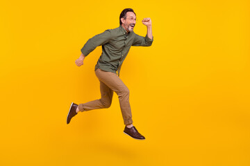 Poster - Full length body size view of attractive cheerful man employee jumping running isolated over bright yellow color background