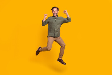 Canvas Print - Full length body size view of attractive cheerful man jumping celebrating isolated over vivid yellow color background