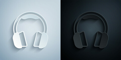 Paper cut Headphones icon isolated on grey and black background. Earphones. Concept for listening to music, service, communication and operator. Paper art style. Vector