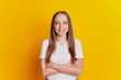 © Tetiana - Photo of young attractive girl crossed hands happy positive smile confident isolated over yellow background