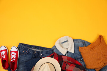 Wall Mural - Concept of winter clothes on yellow background