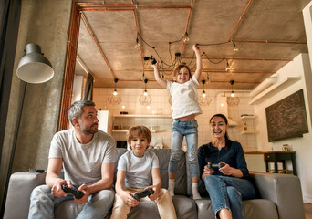 Wall Mural - Happy family with kids enjoy playing video game