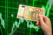 Euro EU banknote on a green stock chart background with dynamics of exchange rates and financial graphs. Trading and financial risk concept photo