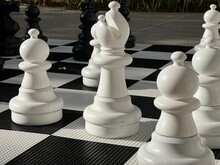 White Chess Pieces On A Chessboard