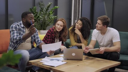 Happy business positive multicultural young people in casual brainstorming at office