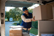 © littlewolf1989 - Deliveryman arranging packages in his van before delivering.