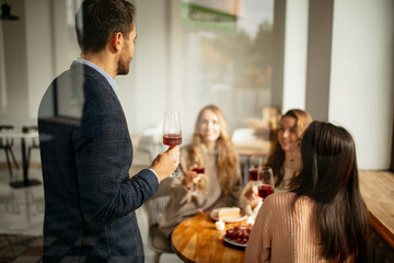 Wall Mural - Cropped portrait of four friends celebrating event, man saying greeting speech