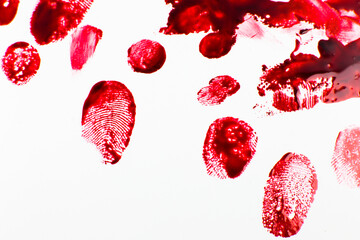Fototapeta red bloody fingerprints on the white background. horror and crime scene concept. halloween postcard.