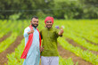 © Niks Ads - Young indian farmers showing thumps up at green turmeric agriculture field.