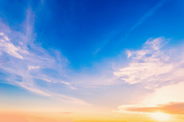Wall Mural - Sky blue and orange light of the sun through the clouds in the sky