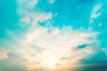 Wall Mural - Sky blue and orange light of the sun through the clouds in the sky