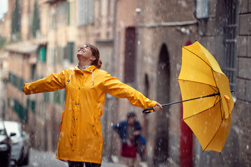 Happy caucasian woman enjoying rainy day