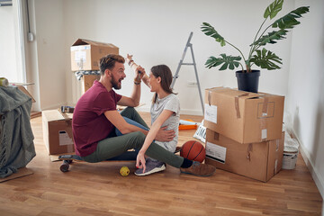 Wall Mural - Happy man and woman with key of new home