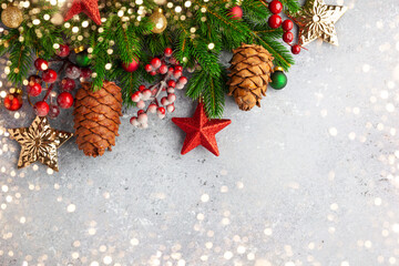 Wall Mural - christmas or new year background with green fir branches, red berries, christmas ornaments and cones