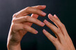 © Konstantin - Female hands illuminated by light on dark background