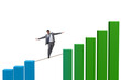 © Elnur - Businessman walking on tight rope between bar chart