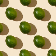  Trendy sunlight summer pattern made with green lime on bright light yellow background. Minimal summer concept. Flat lay.